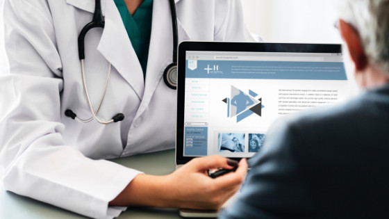 A Doctor showing his options to a patient on a computer