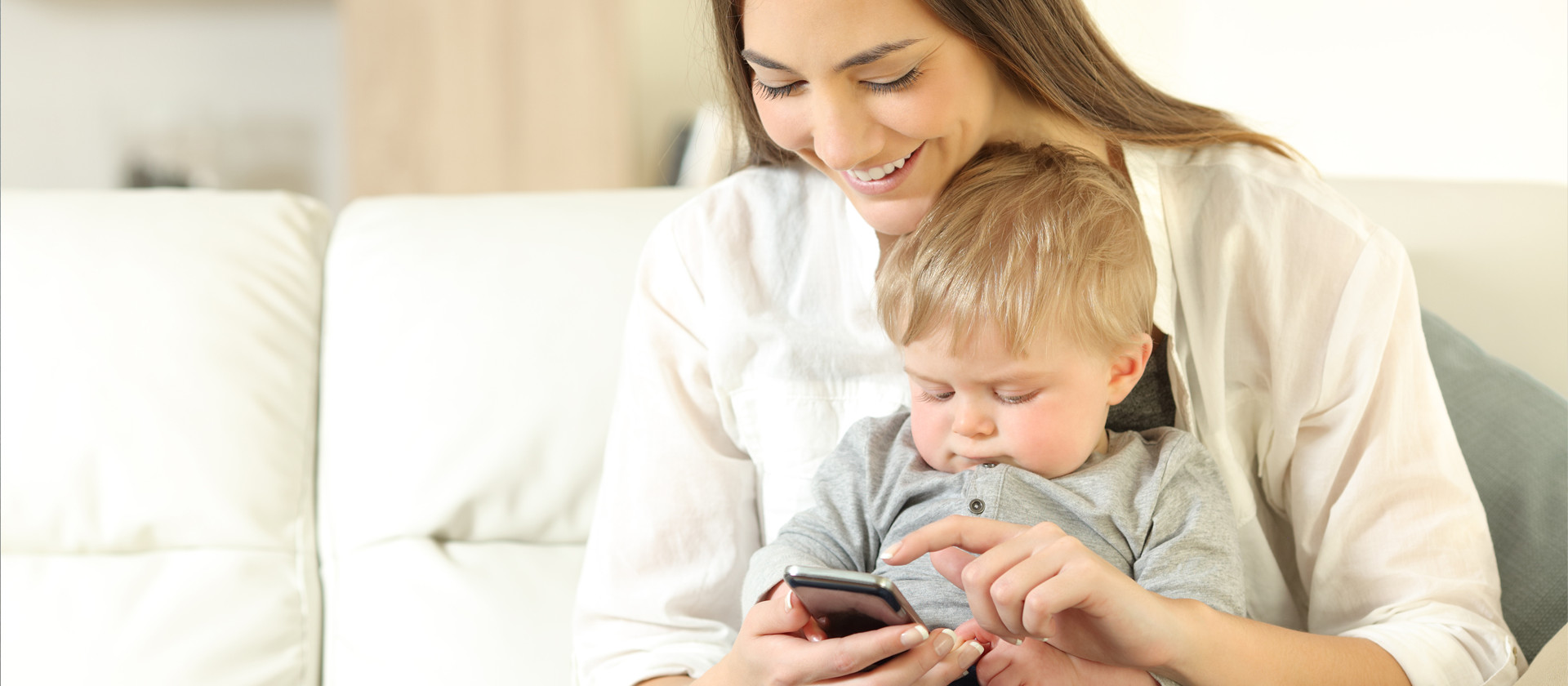 A mother and her son using her smartphone